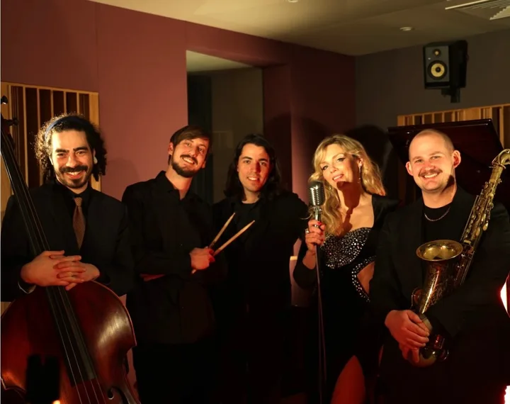 Oli Gosh with her band in a recording studio