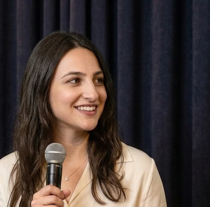 Close, smiling, with a microphone