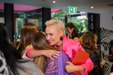 Maria Semushkina hugging a guest