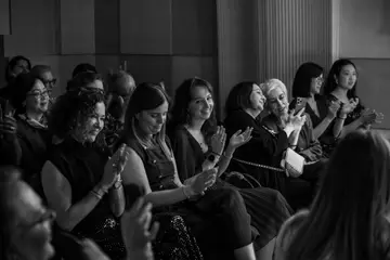 Women in the audience applauding